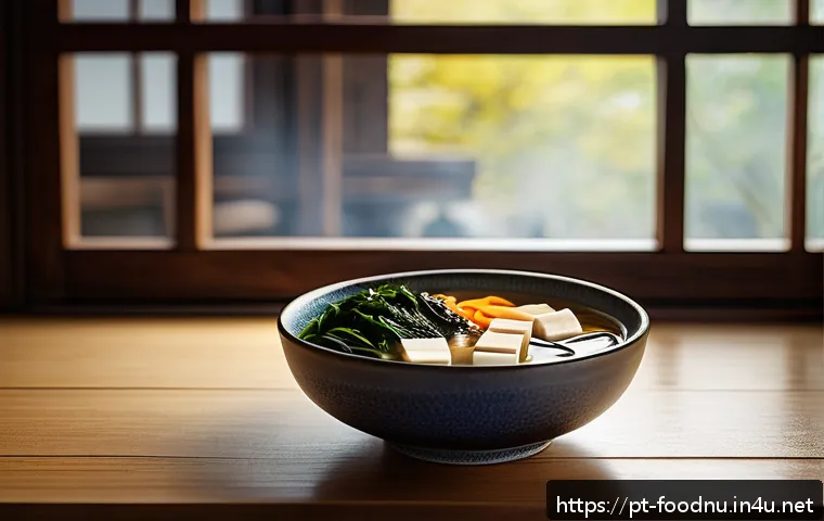 된장과 항암 효과 - A warm, inviting traditional Japanese kitchen scene featuring a steaming bowl of miso soup with tofu...